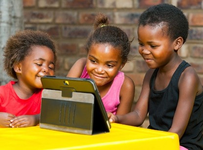 African American Children in front of a tablet